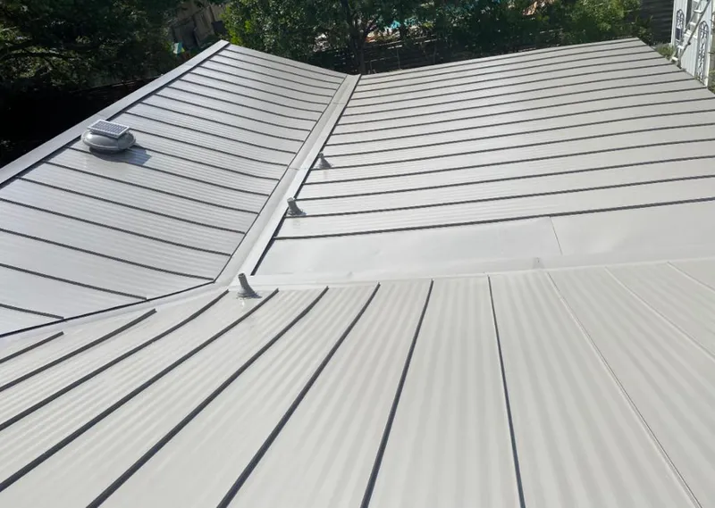 Solar attic fan installed on a metal roof for Roof Ventilation in Beaumont